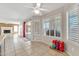 Bright living area featuring neutral tile flooring, shutters, and sliding glass doors for seamless indoor-outdoor living at 8871 W Maryland Ave, Glendale, AZ 85305