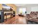 Cozy living room with hardwood floors, a large TV, and comfortable seating at 8871 W Maryland Ave, Glendale, AZ 85305