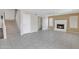 Open living room with tile floors, a traditional fireplace, and easy access to the upstairs and bathroom at 8871 W Maryland Ave, Glendale, AZ 85305