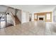Spacious living room with tile floors, a fireplace, and a staircase leading to the upper level at 8871 W Maryland Ave, Glendale, AZ 85305