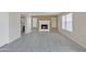 Bright and airy living room with neutral tile floors, a traditional fireplace, and ample natural light at 8871 W Maryland Ave, Glendale, AZ 85305