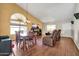 Open-concept living room featuring hardwood floors, dining area, and cozy seating at 8871 W Maryland Ave, Glendale, AZ 85305