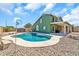 Backyard featuring a private in-ground swimming pool with rock landscaping and a covered patio at 8871 W Maryland Ave, Glendale, AZ 85305
