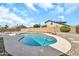 Backyard featuring a private in-ground swimming pool with rock landscaping and perimeter seating at 8871 W Maryland Ave, Glendale, AZ 85305