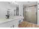 Elegant bathroom showcasing dual sinks, modern fixtures, and a glass-enclosed shower with tile surround at 9343 W Harmony Ln, Peoria, AZ 85382