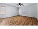 Spacious bedroom with hardwood floors, ceiling fan and plenty of natural light from multiple windows at 9343 W Harmony Ln, Peoria, AZ 85382