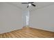 This is a bright bedroom with a ceiling fan, wood floors, and a bathroom at 9343 W Harmony Ln, Peoria, AZ 85382