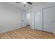 This is a bright bedroom with a ceiling fan, wood floors, and a closet at 9343 W Harmony Ln, Peoria, AZ 85382