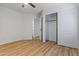 This is a bright bedroom with a ceiling fan, wood floors, and a closet at 9343 W Harmony Ln, Peoria, AZ 85382