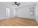 Bright bedroom featuring hardwood floors, a ceiling fan and three windows for plenty of natural light at 9343 W Harmony Ln, Peoria, AZ 85382