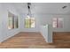 Bright dining area with wood floors, modern chandelier, and plenty of natural light at 9343 W Harmony Ln, Peoria, AZ 85382