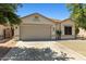 Charming single-story home with neutral stucco, a two-car garage, and desert landscaping at 9343 W Harmony Ln, Peoria, AZ 85382