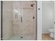 A glass shower stall featuring a mosaic floor and white marble tile surround at 9343 W Harmony Ln, Peoria, AZ 85382