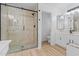 Bathroom shower with a glass door and marble tile surround at 9343 W Harmony Ln, Peoria, AZ 85382