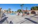 Relaxing community pool area surrounded by lounge chairs and palm trees at 943 E Kortsen Rd # 2, Casa Grande, AZ 85122