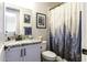 View of bathroom with vanity, sink, toilet, and shower with forest-themed curtain at 943 E Kortsen Rd # 2, Casa Grande, AZ 85122