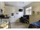 Bedroom with reptile enclosure, desk, television, and decor at 943 E Kortsen Rd # 2, Casa Grande, AZ 85122