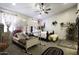 Charming bedroom features a double bed, carpeted floors, a ceiling fan, and floral curtains at 943 E Kortsen Rd # 2, Casa Grande, AZ 85122