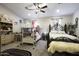 Large bedroom features a double bed and a bunk bed, carpeted floors, a ceiling fan, and decor at 943 E Kortsen Rd # 2, Casa Grande, AZ 85122