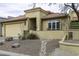 Charming tan home with a tile roof, desert landscaping, and a welcoming front entrance at 943 E Kortsen Rd # 2, Casa Grande, AZ 85122