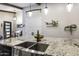 Close up view of the kitchen island featuring granite countertops, a stainless steel farmhouse sink, and pendant lighting at 943 E Kortsen Rd # 2, Casa Grande, AZ 85122
