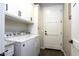 Well-lit laundry room featuring a modern washer and dryer set with white cabinets at 943 E Kortsen Rd # 2, Casa Grande, AZ 85122