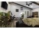 Comfortable living room featuring hardwood floors, exposed beams, a ceiling fan, sliding glass doors, and a sectional couch at 943 E Kortsen Rd # 2, Casa Grande, AZ 85122