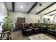 Spacious living room with hardwood floors, exposed beams, a ceiling fan, and comfortable seating area with decor at 943 E Kortsen Rd # 2, Casa Grande, AZ 85122