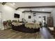 Living room features wood floors, neutral walls, a comfortable couch, and a sliding glass door to the backyard at 943 E Kortsen Rd # 2, Casa Grande, AZ 85122