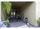 Cozy covered patio area with brick flooring, ceiling fan, and potted plants at 943 E Kortsen Rd # 2, Casa Grande, AZ 85122