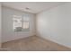 Cozy bedroom with plush carpet and a large window for natural light at 1058 W Swan Dr, Chandler, AZ 85286