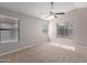 Spacious bedroom with neutral carpet, ample natural light, and ceiling fan at 1058 W Swan Dr, Chandler, AZ 85286