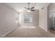 Bright, carpeted bedroom with high ceilings, ceiling fan, and multiple windows at 1058 W Swan Dr, Chandler, AZ 85286