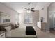 Bedroom with neutral walls, ceiling fan, natural light, and ensuite bath at 1058 W Swan Dr, Chandler, AZ 85286