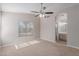 Large bedroom with carpet, ceiling fan, and access to the ensuite bathroom at 1058 W Swan Dr, Chandler, AZ 85286