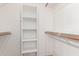 Organized walk-in closet features shelving, hanging rods, and a carpeted floor at 1058 W Swan Dr, Chandler, AZ 85286
