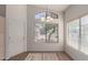 Sunlit dining room features a stylish chandelier, large window, and adjacent door at 1058 W Swan Dr, Chandler, AZ 85286