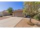 Charming single Gathering home with a two-car garage, tile roof, and desert landscaping at 1058 W Swan Dr, Chandler, AZ 85286