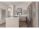Bright kitchen boasts stainless steel appliances, light wood cabinets, and an island with white countertop at 1058 W Swan Dr, Chandler, AZ 85286