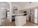 Well-lit kitchen features stainless steel appliances, an island with a white countertop and adjacent living area at 1058 W Swan Dr, Chandler, AZ 85286