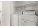 Laundry room featuring the washer, dryer, and built in shelves for storage at 1058 W Swan Dr, Chandler, AZ 85286