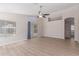 Bright living room featuring wood flooring, a ceiling fan, and sliding glass doors at 1058 W Swan Dr, Chandler, AZ 85286