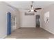 Bright living room with wood flooring, a ceiling fan, and neutral paint colors at 1058 W Swan Dr, Chandler, AZ 85286