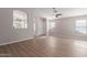 Bright living room featuring wood flooring, large windows, and an open floor plan at 1058 W Swan Dr, Chandler, AZ 85286