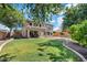 Expansive backyard featuring a covered patio, lush green lawn, and a sparkling swimming pool, perfect for outdoor living at 11129 E Reginald Ave, Mesa, AZ 85212