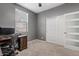 A simple bedroom features carpet, a large closet, and a bright window with views at 11129 E Reginald Ave, Mesa, AZ 85212