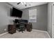 Bedroom with carpet features a large desk, and a bright window with blinds at 11129 E Reginald Ave, Mesa, AZ 85212