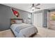 A bedroom featuring neutral carpet, ceiling fan, closet, and sports themed decor at 11129 E Reginald Ave, Mesa, AZ 85212