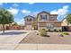 Two-story home features a two-car garage, neutral stucco, desert landscaping, and a concrete driveway at 11129 E Reginald Ave, Mesa, AZ 85212