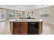 Open kitchen featuring a central island, wood cabinets, and stainless steel dishwasher appliance at 11129 E Reginald Ave, Mesa, AZ 85212